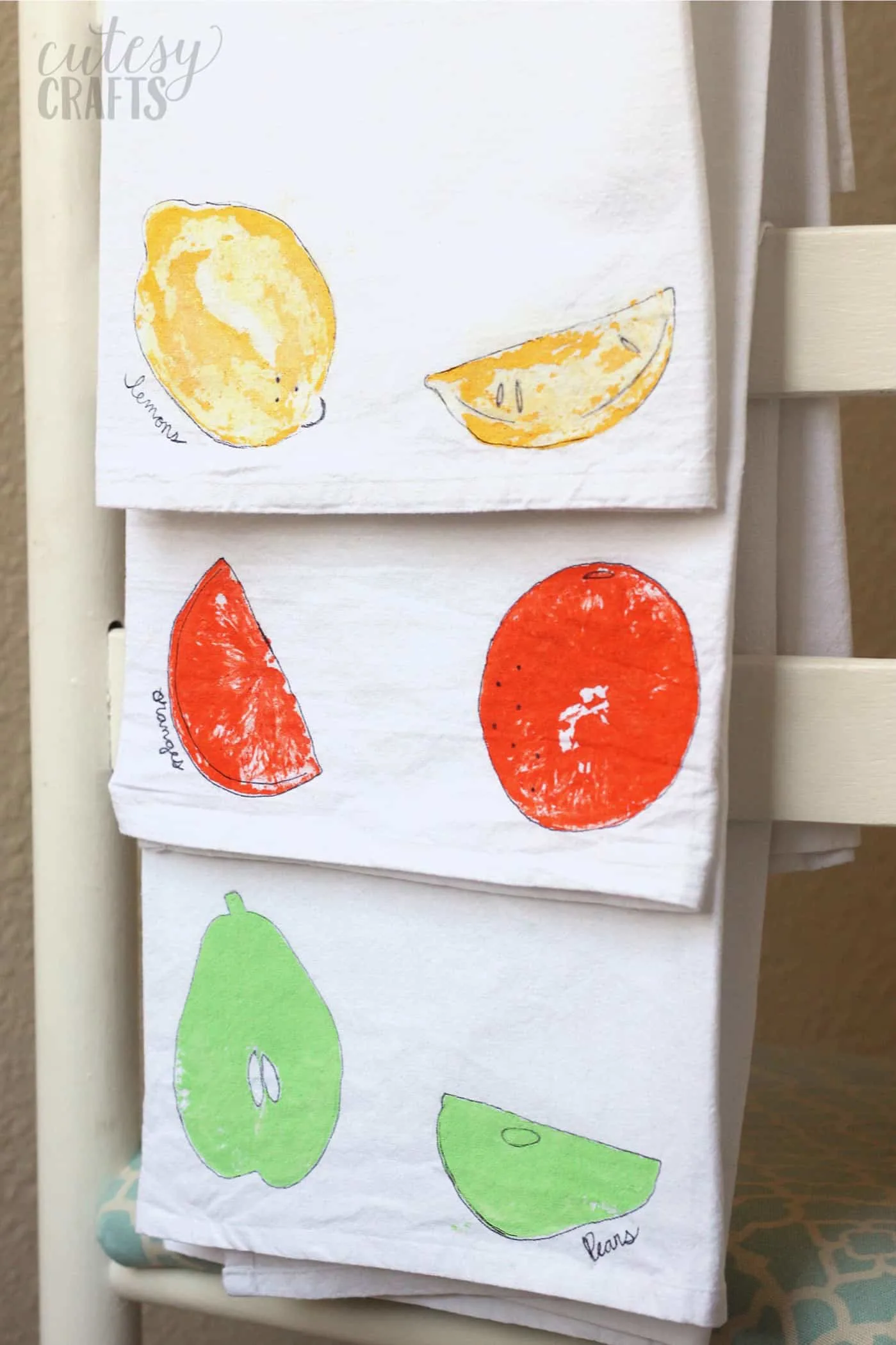 Fruit stamps on tea towels in yellow, orange, and mint