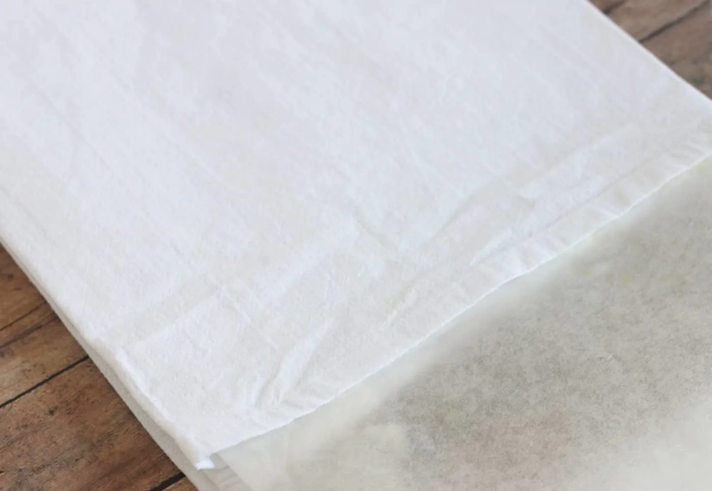 place wax paper in between layers of a tea towel