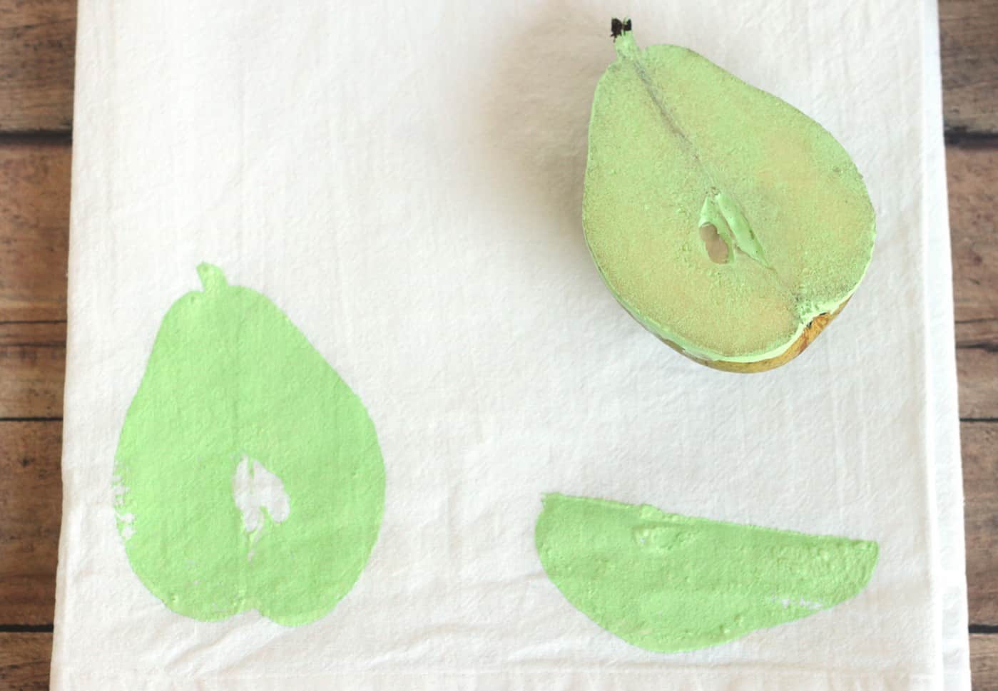 Pear with paint stamped onto fabric