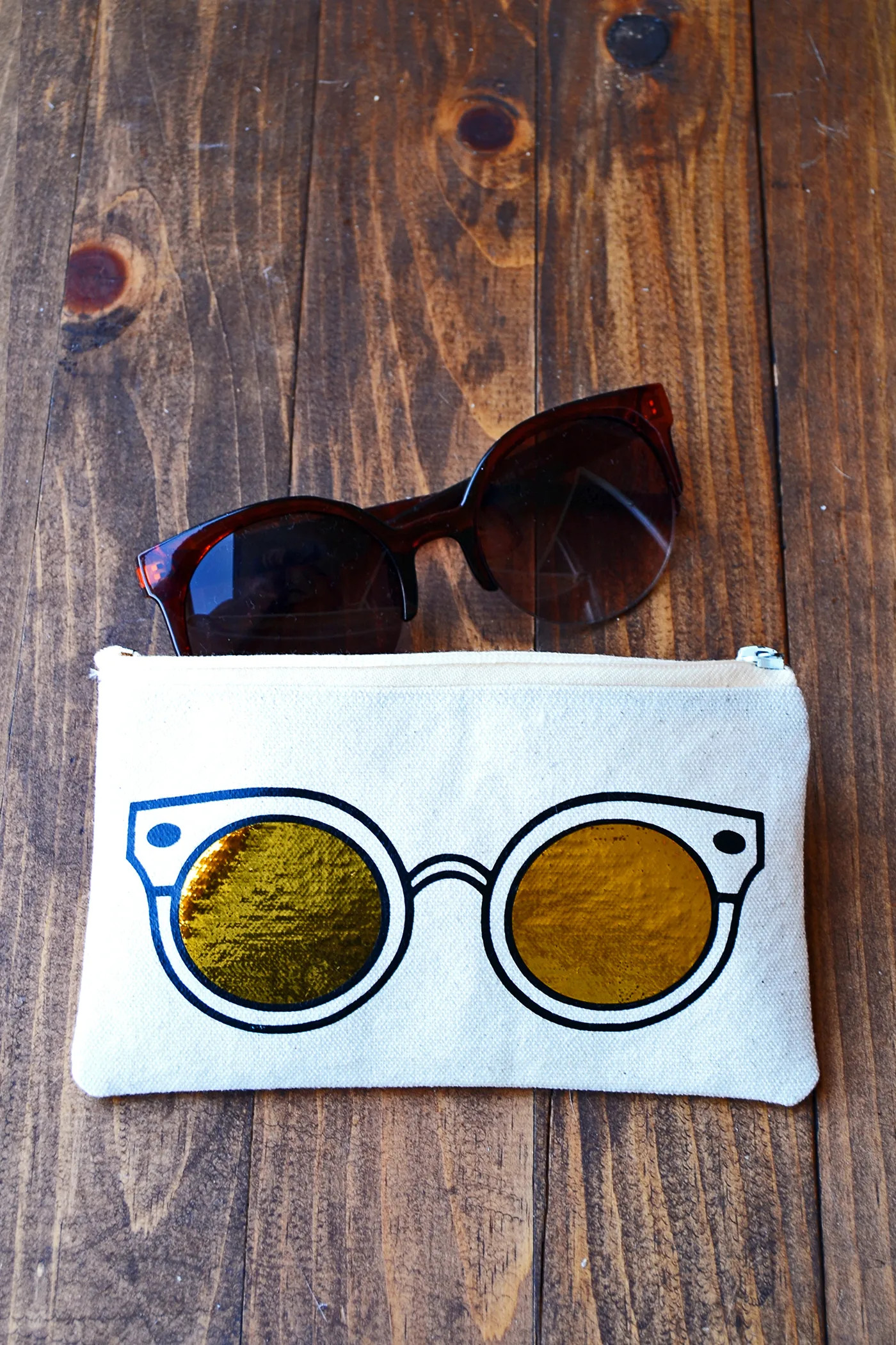 Learn how to make a unique DIY sunglasses case using heat transfer vinyl and a die cutter. This trendy project includes a free template!