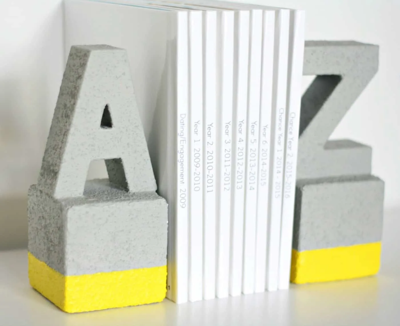 DIY faux concrete bookends using foam bricks and paper mache letters