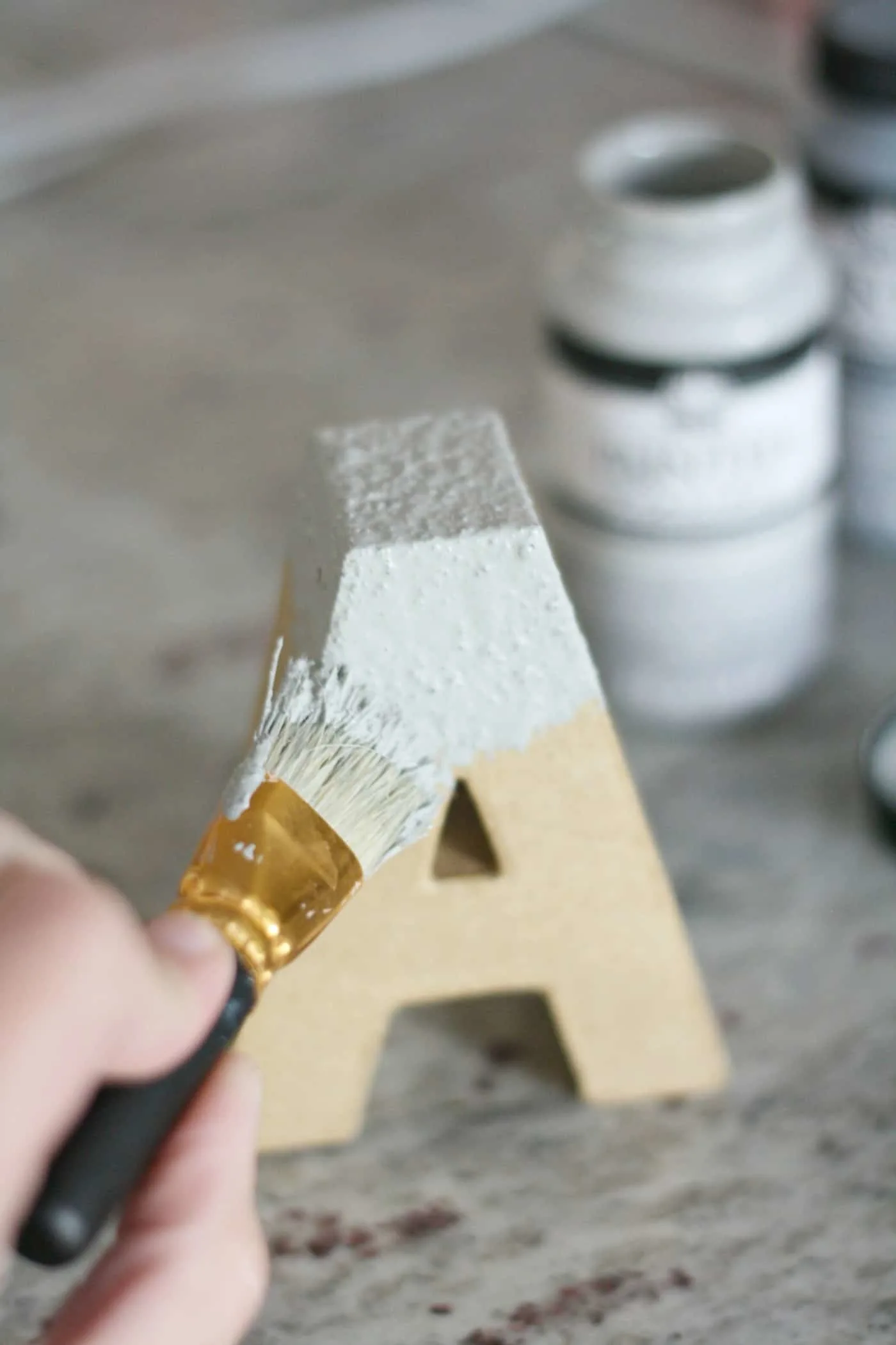 Applying the concrete finish to the paper mache letter