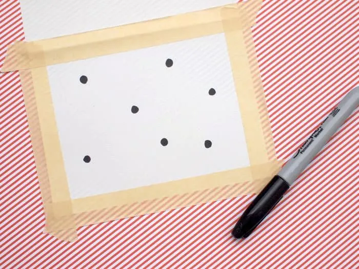 Masking tape border around the front of the card with black dots