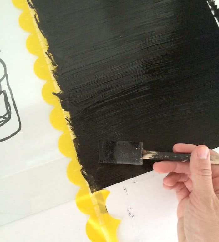 Painting a second layer of chalkboard paint on the glass