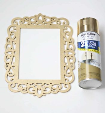 Laser cut wood overlay and a can of gold spray paint