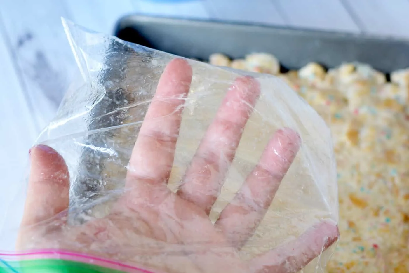Hand with a sandwich bag on it