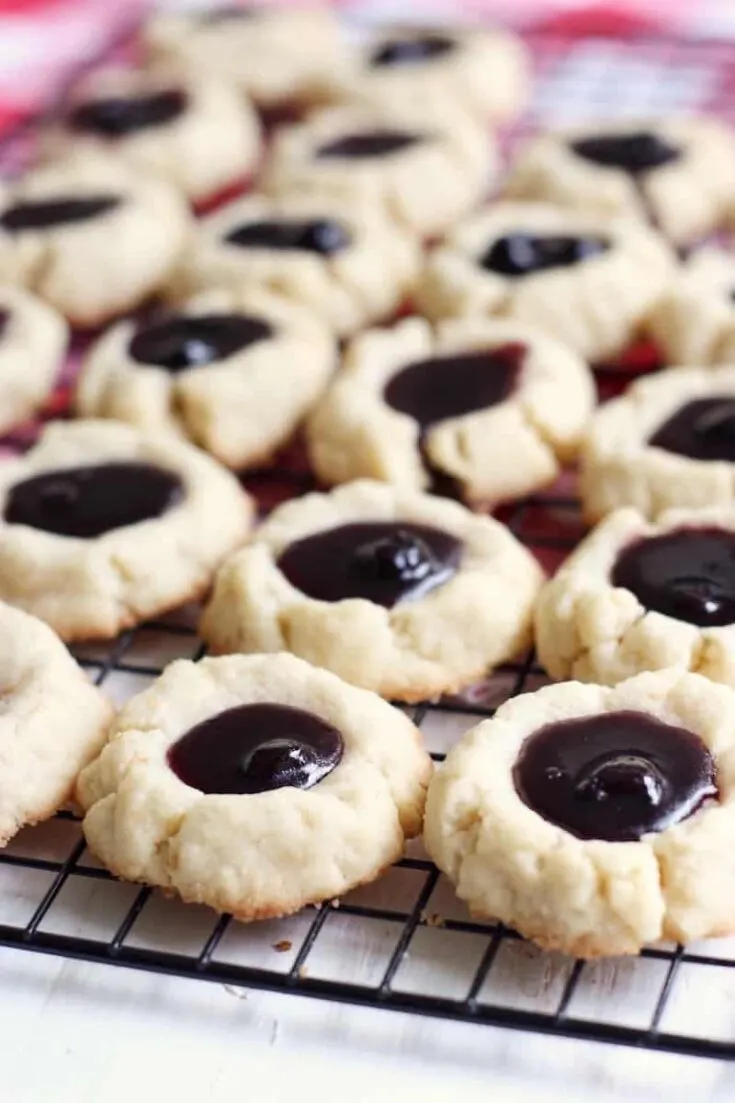 Blueberry thumbprint cookies laid out on a wire rack