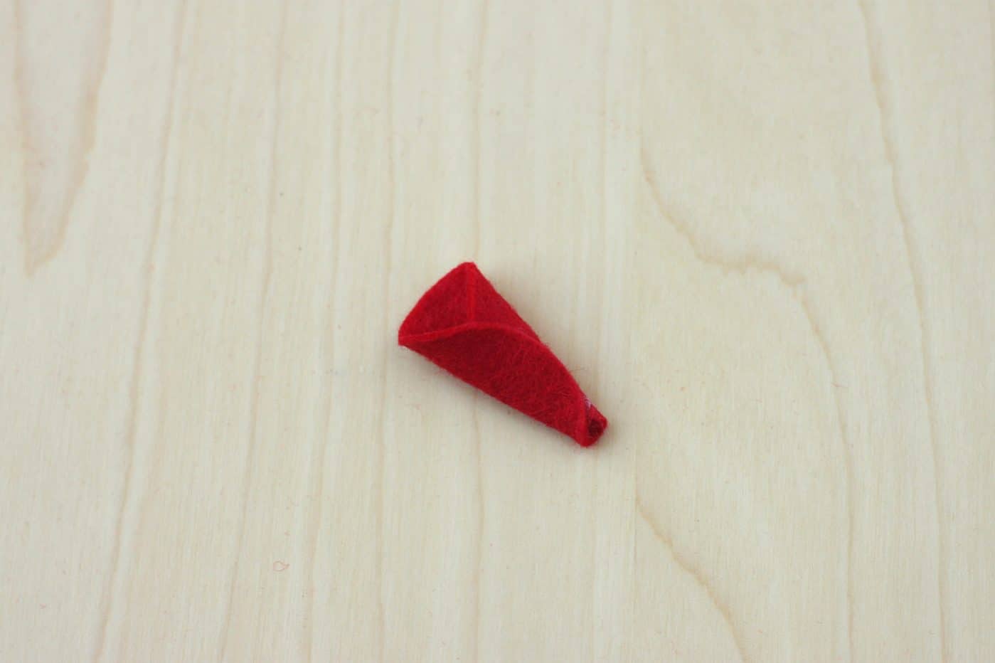 Small red felt circle rolled into a cone