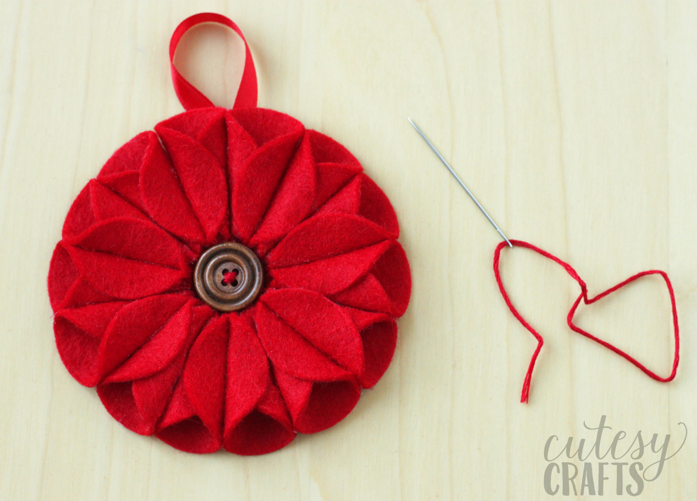 Button sewn into the middle of an poinsettia ornament