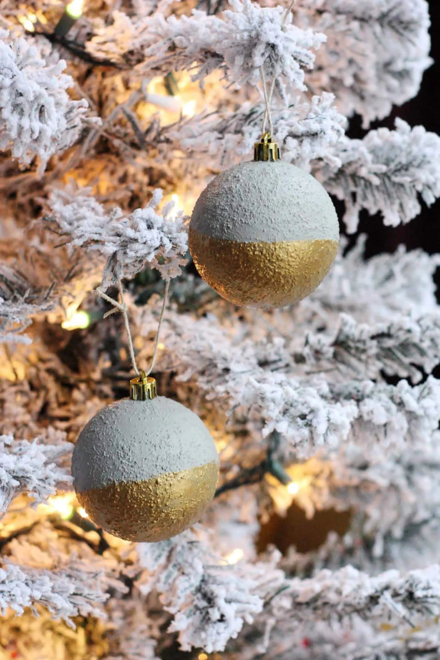 Modern concrete ornaments on a flocked Christmas tree