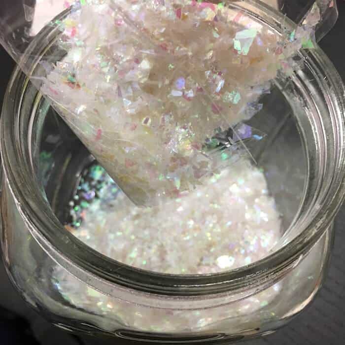 Pouring artificial snow into a glass jar
