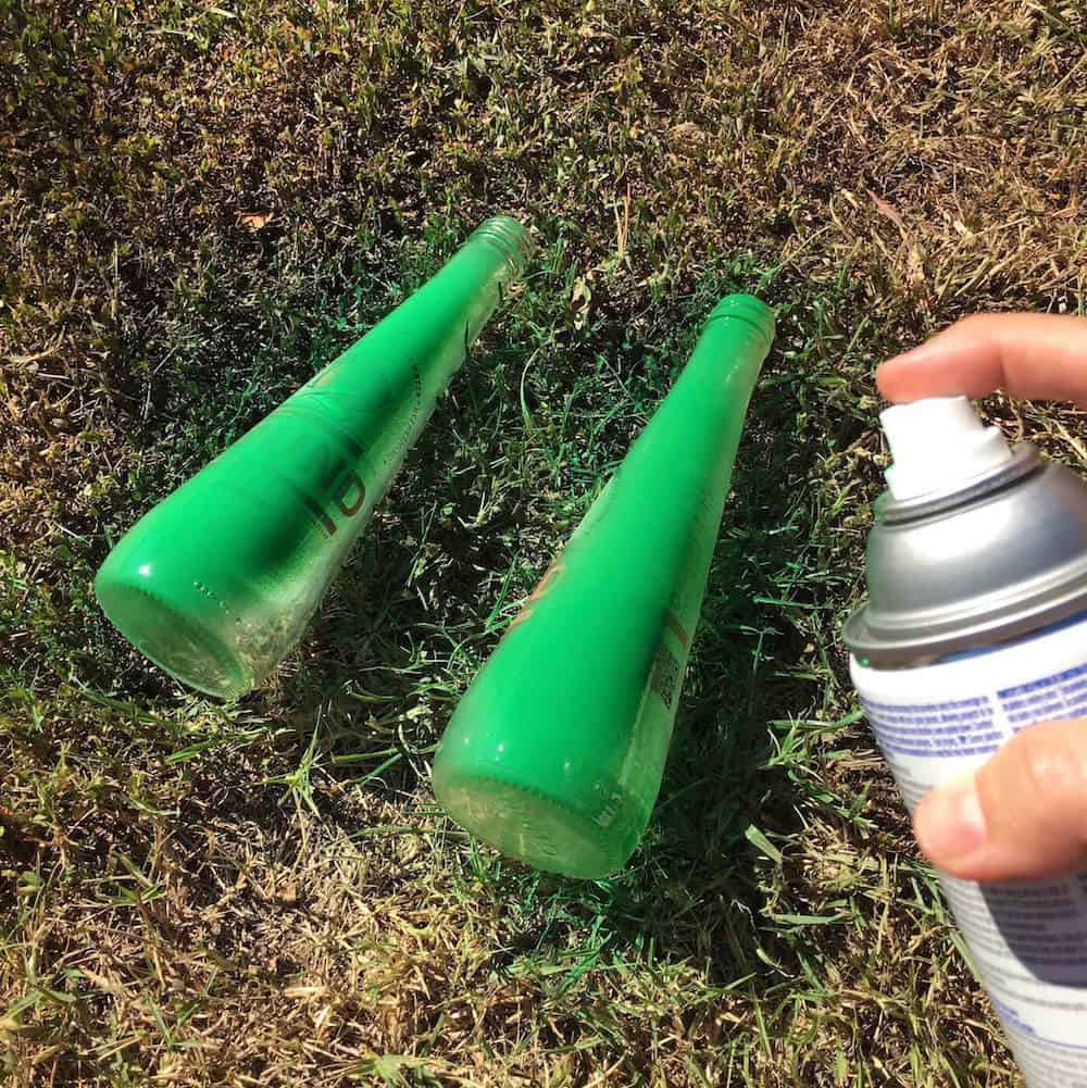 Spray paint the two bottles with green spray paint