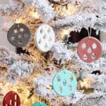 DIY clay Christmas ornaments hanging from a frosted tree