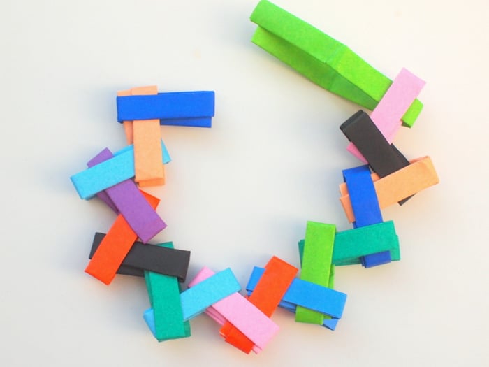 Make an origami paper chain and fold into a circle