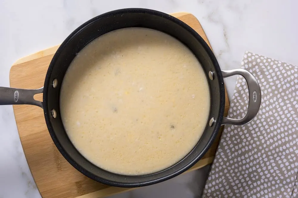 Stir cream of chicken and cream of mushroom soups together in a saucepan