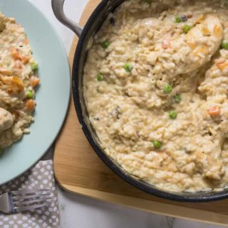chicken and pea risotto in a saucepan and on a plate