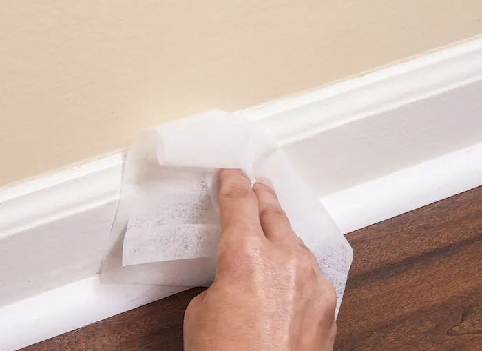 Clean baseboards with dryer sheets