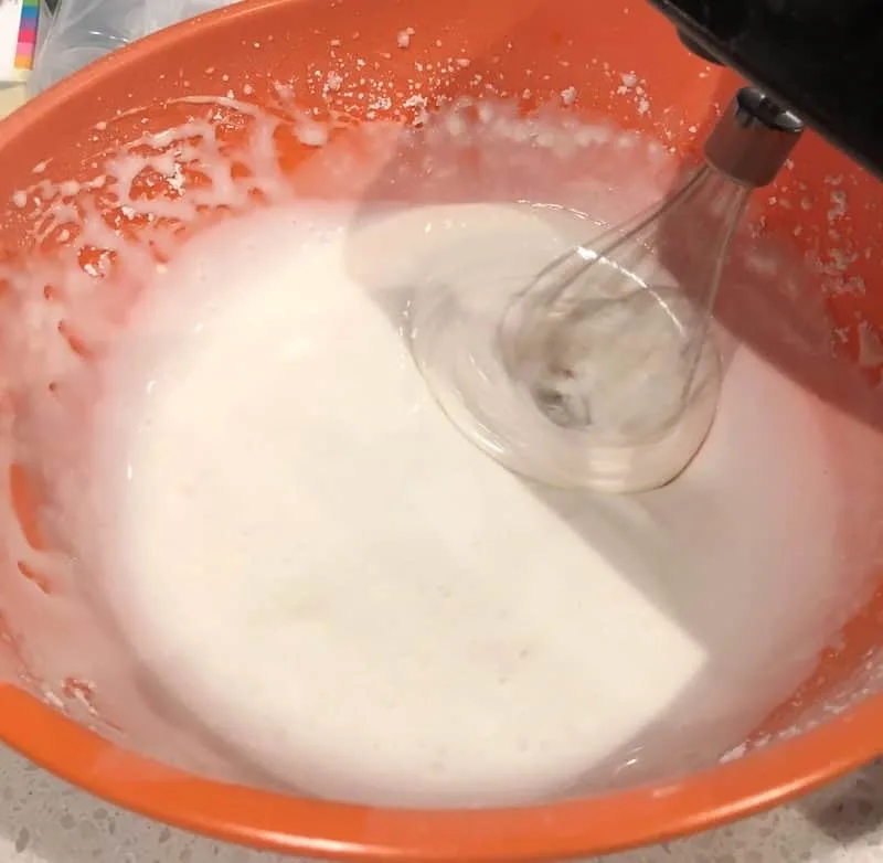 Beating the icing ingredients with an electric mixer