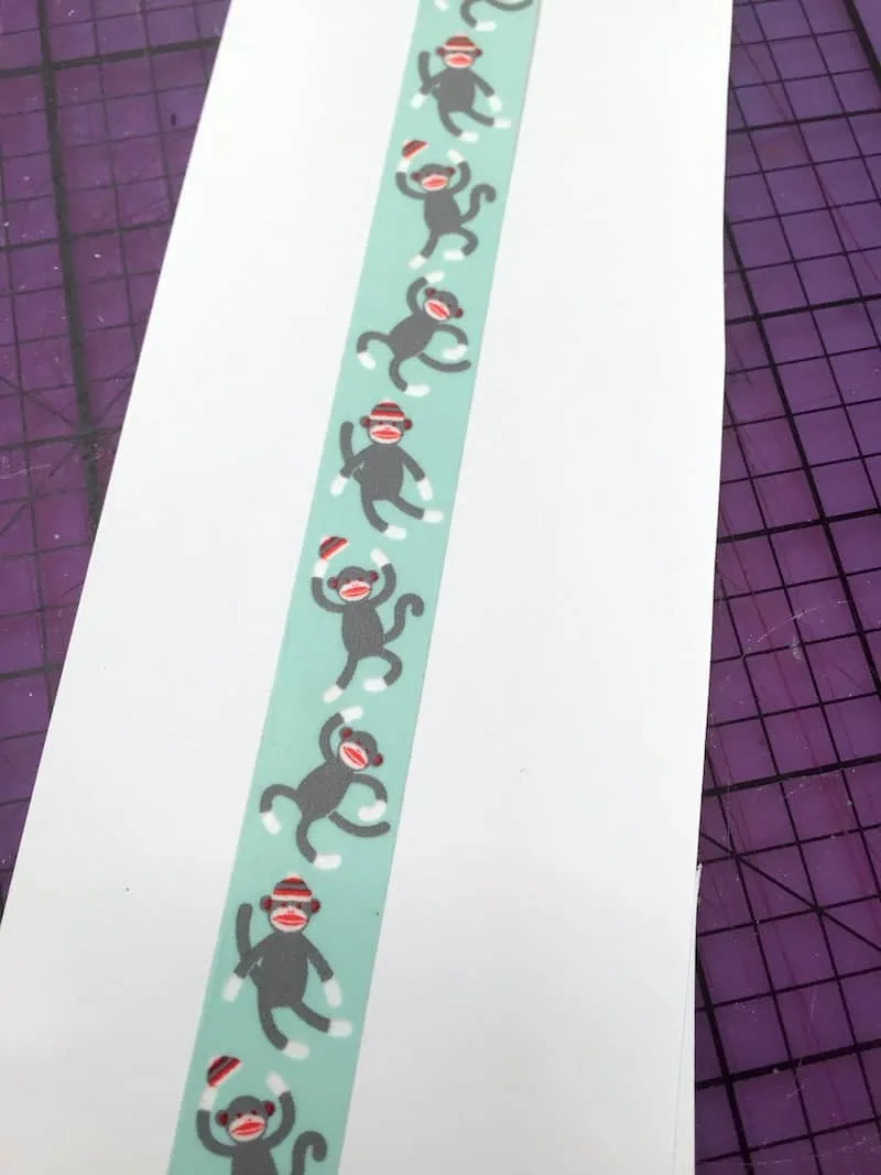 Sock monkey washi tape spread out on a white piece of paper