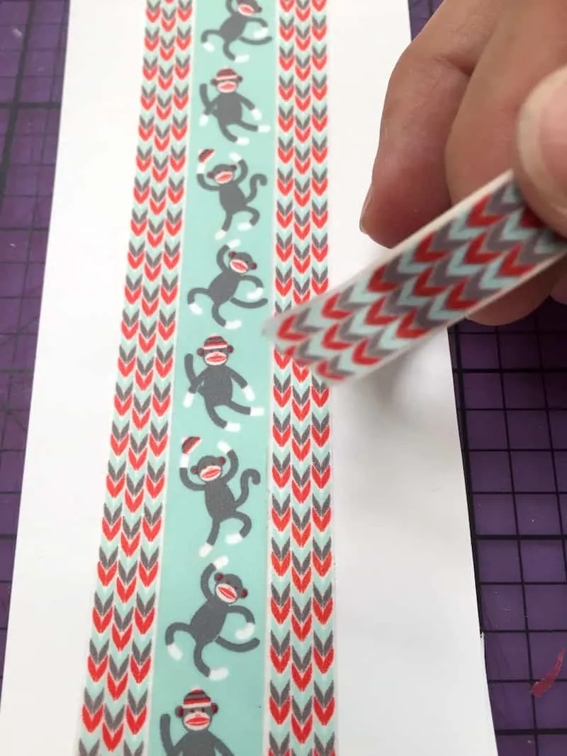 Sock monkey washi tape and chevron washi tape on a white piece of paper