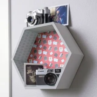Painted and decorated hexagon shelf hanging on the wall