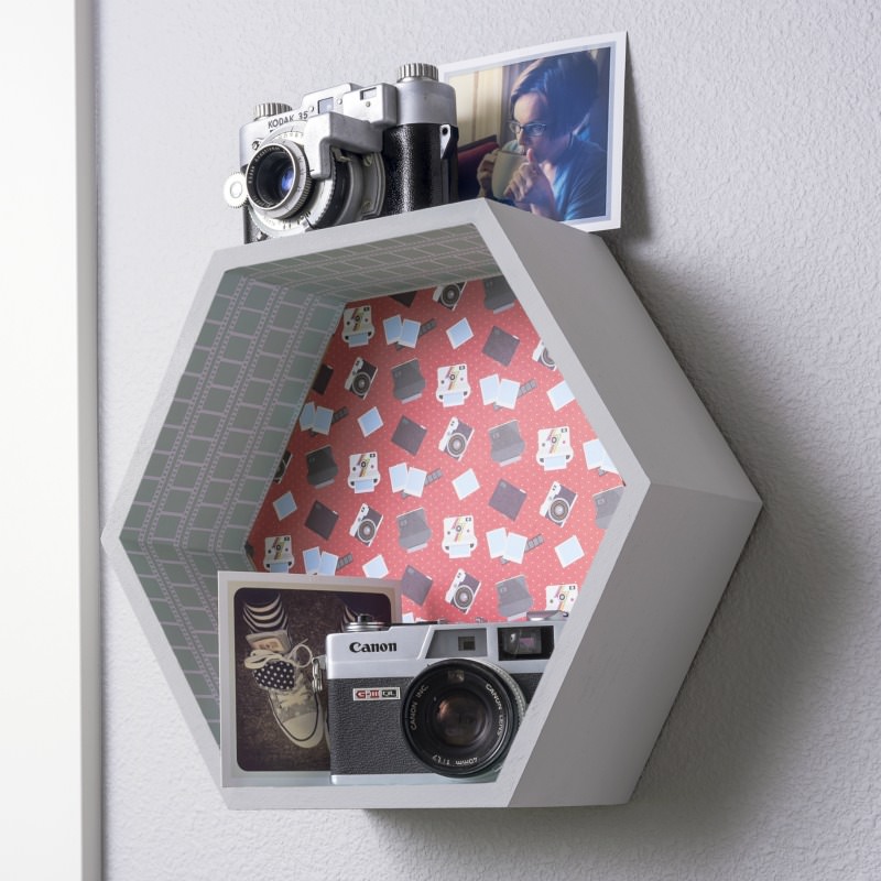 Painted and decorated hexagon shelf hanging on the wall