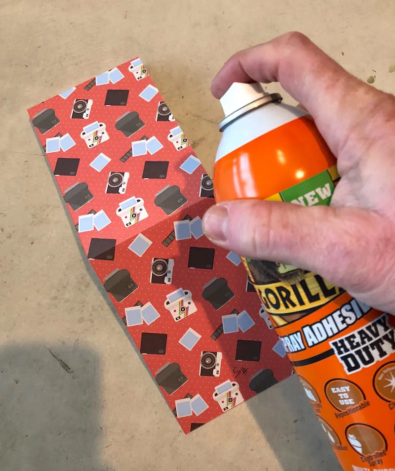 Spraying the paper with spray adhesive