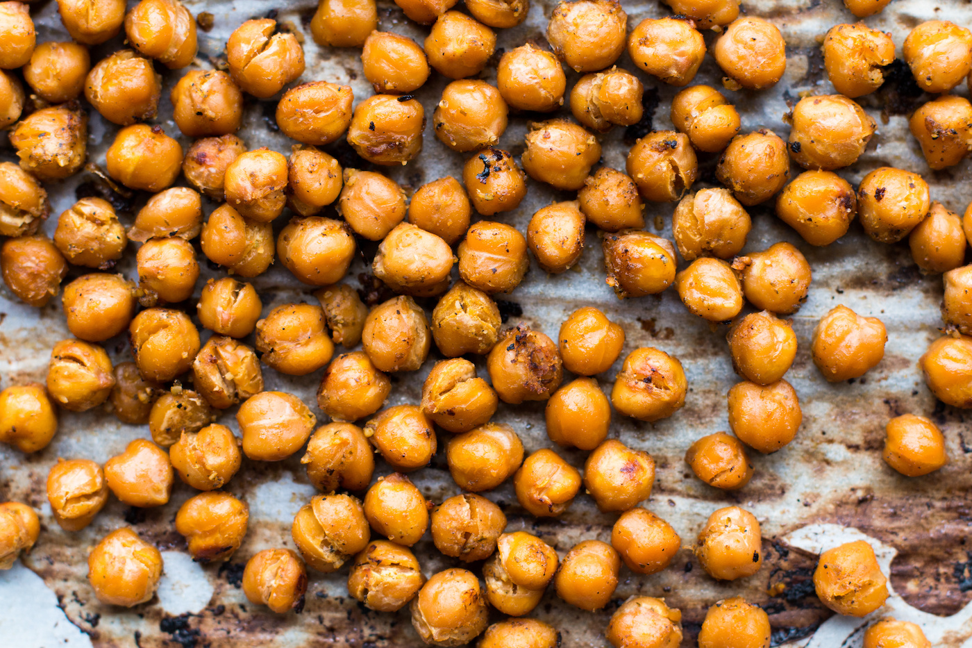 Roasted chickpeas on parchment covered baking sheet