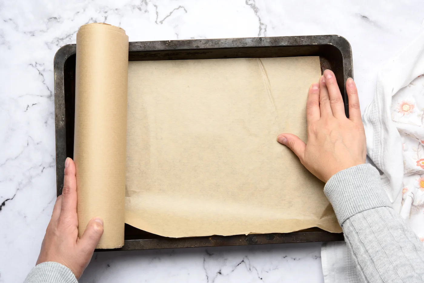 Spreading-parchment-on-a-cookie-sheet