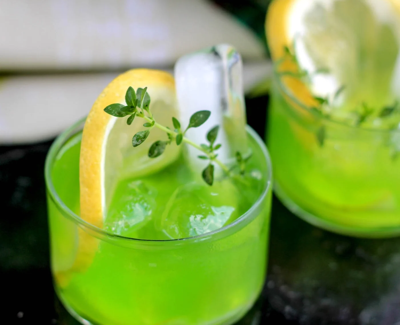 Ectoplasm drink garnished with lemon and rosemary