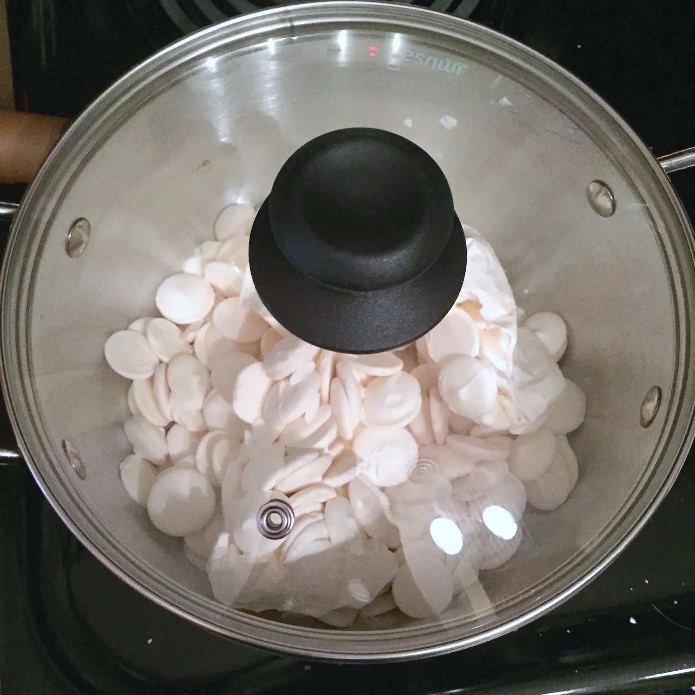 Candy melts in a sauce pan with the lid on