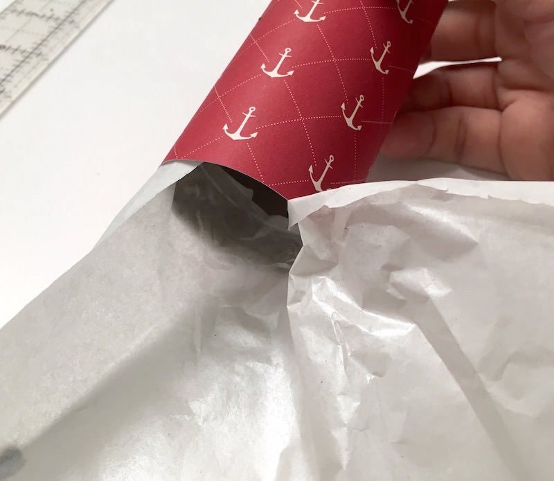 Attach tissue paper to the bottom of the rocket party favor