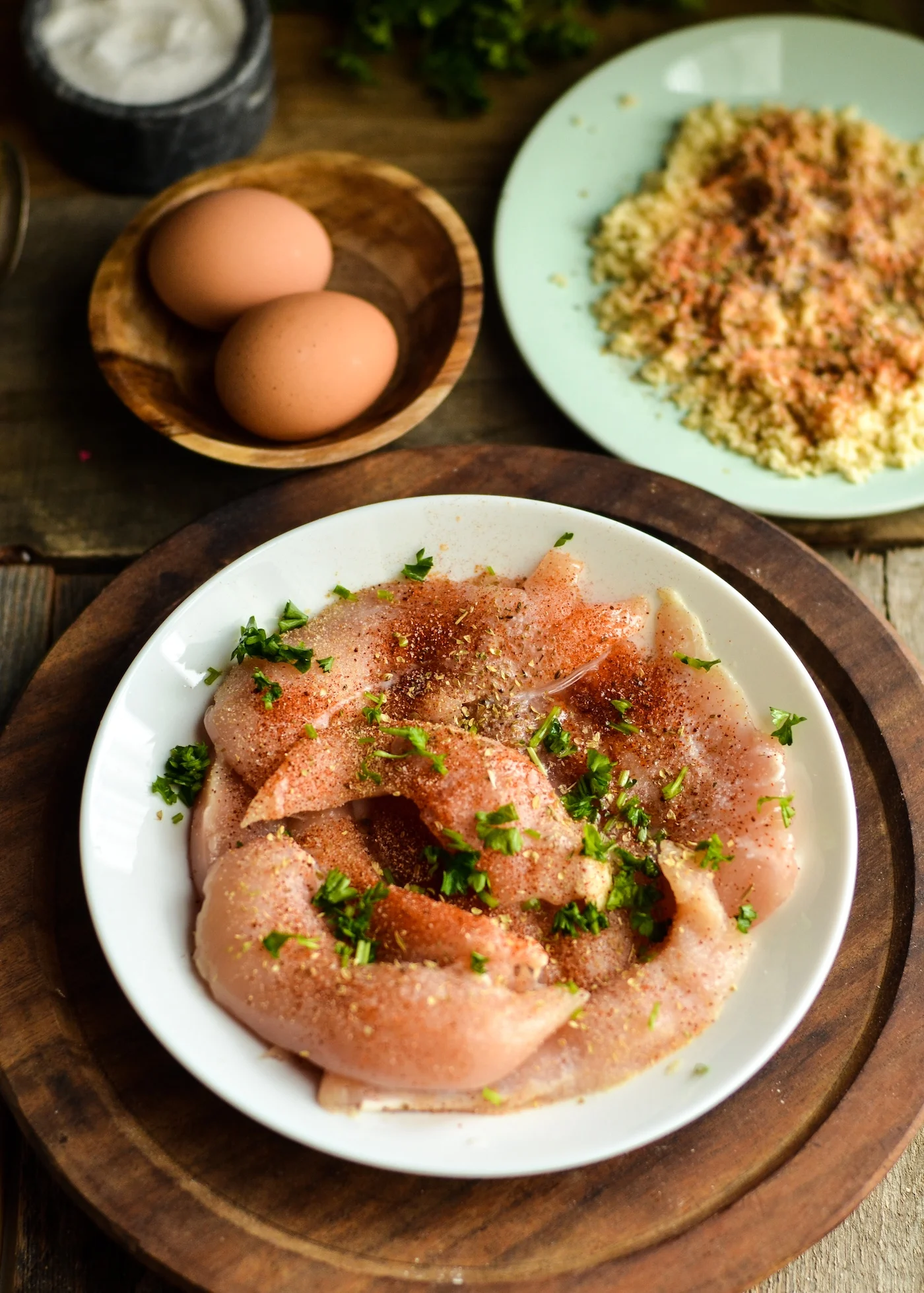 Raw chicken pieces in a bowl with lemon juice and seasoning