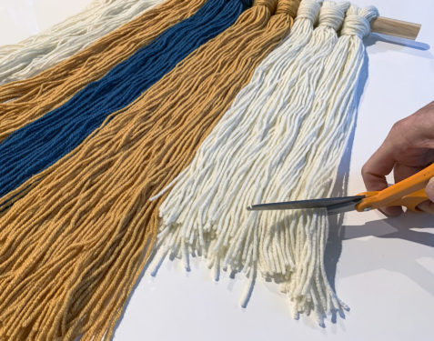 trimming a yarn art wall hanging