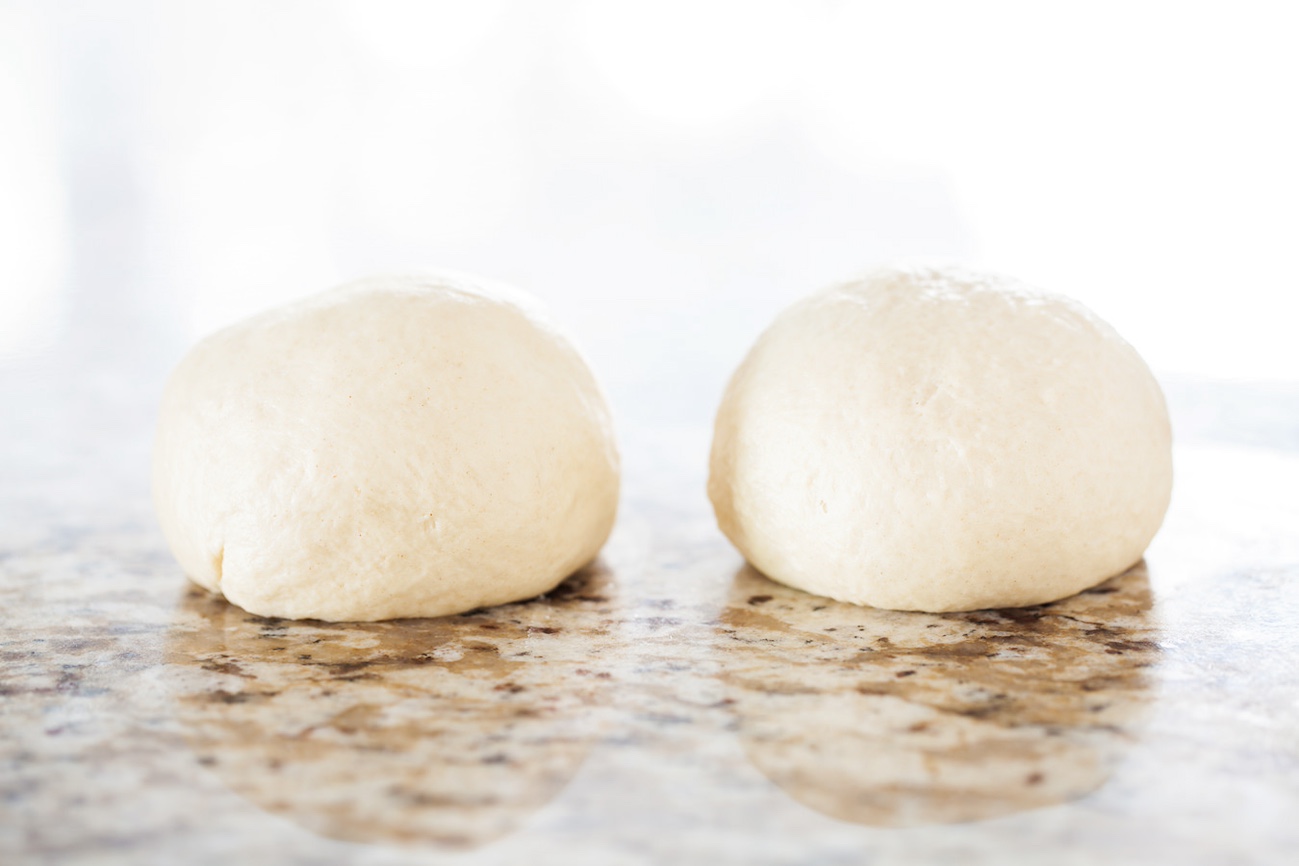 two balls of no yeast dough on a countertop