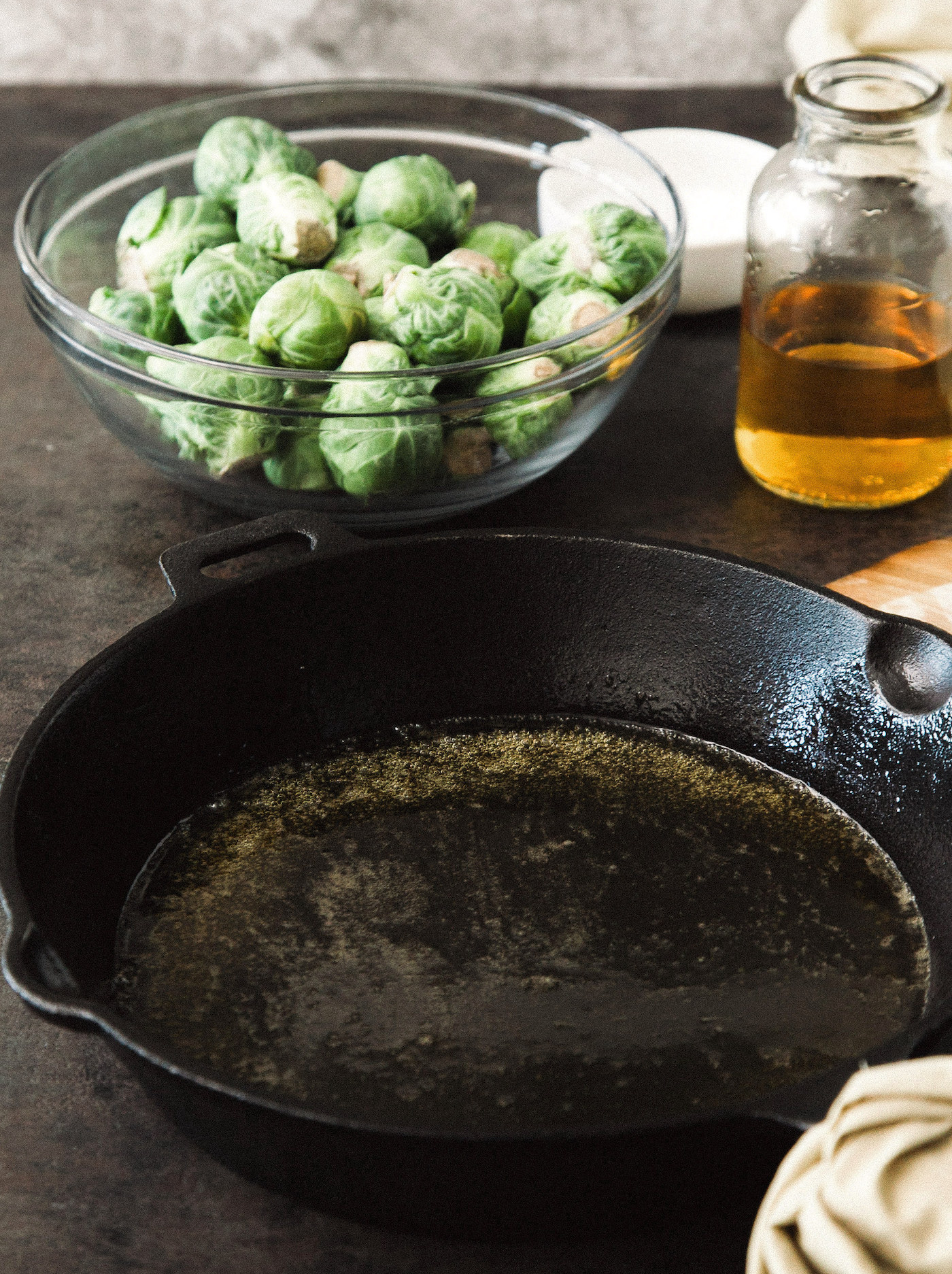 Adding brussels sprouts to the cast iron pan