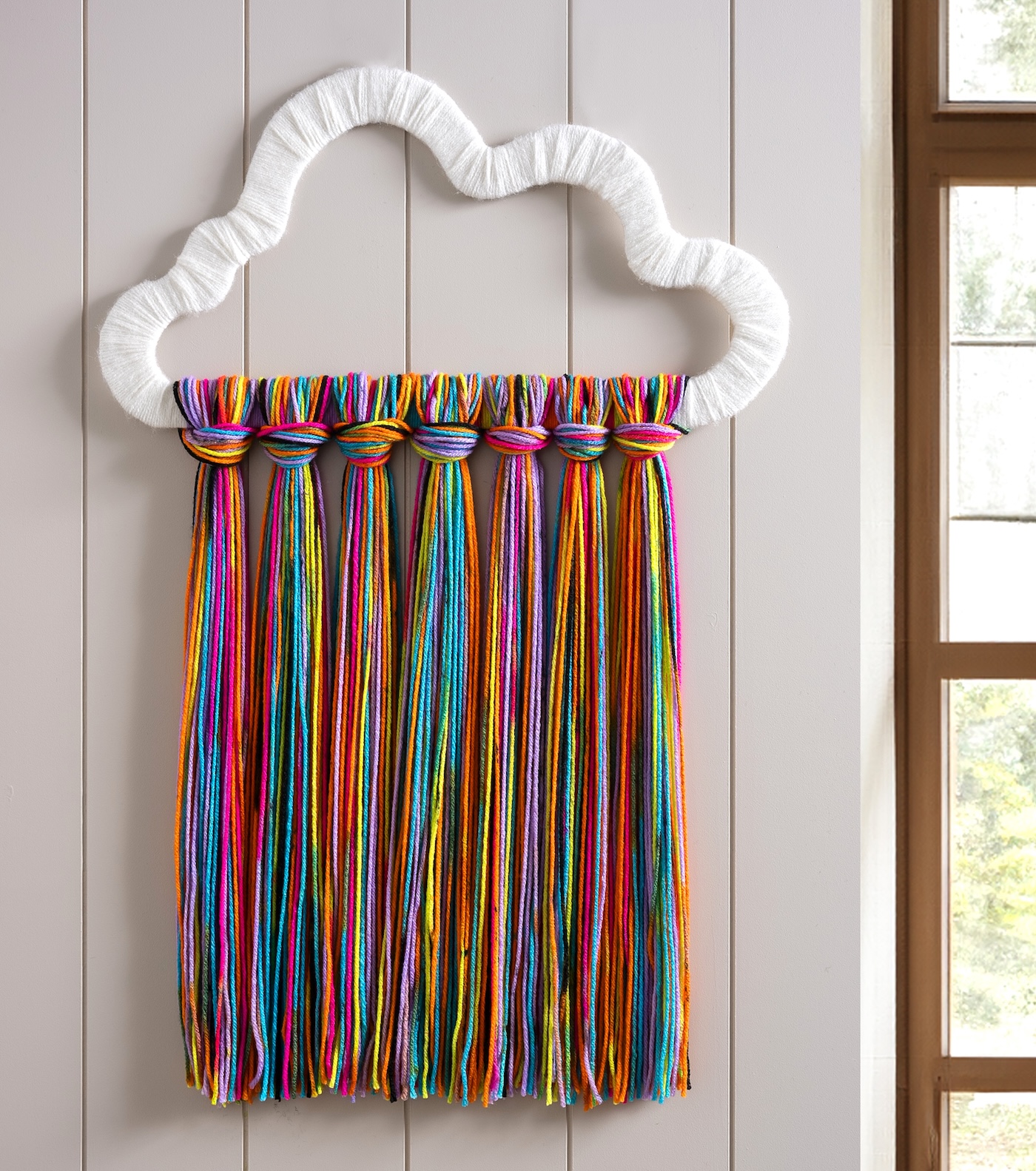 DIY rainbow yarn wall art