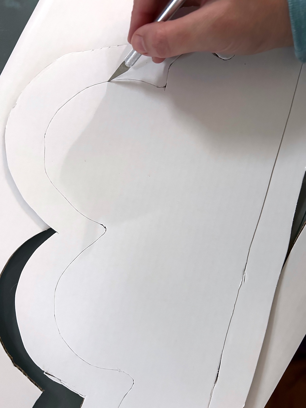 cutting out a cloud shape with craft knife