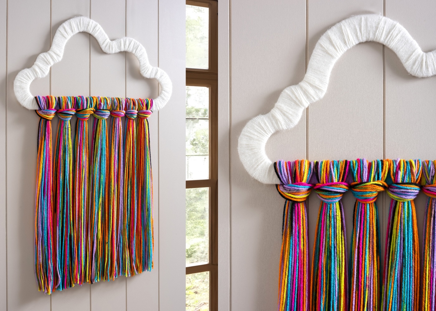 rainbow yarn art hanging on the wall