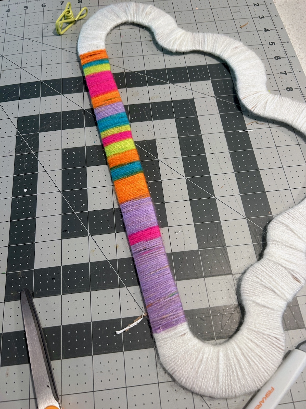 rainbow yarn wrapped around the bottom of the cloud shape