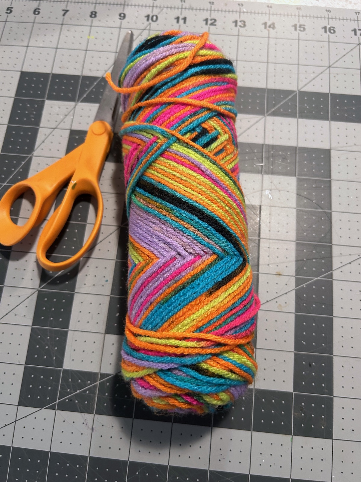 skein of rainbow yarn and scissors