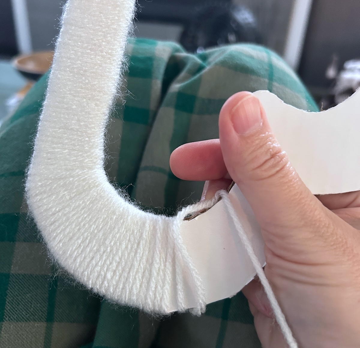 wrapping white yarn around the cloud shape