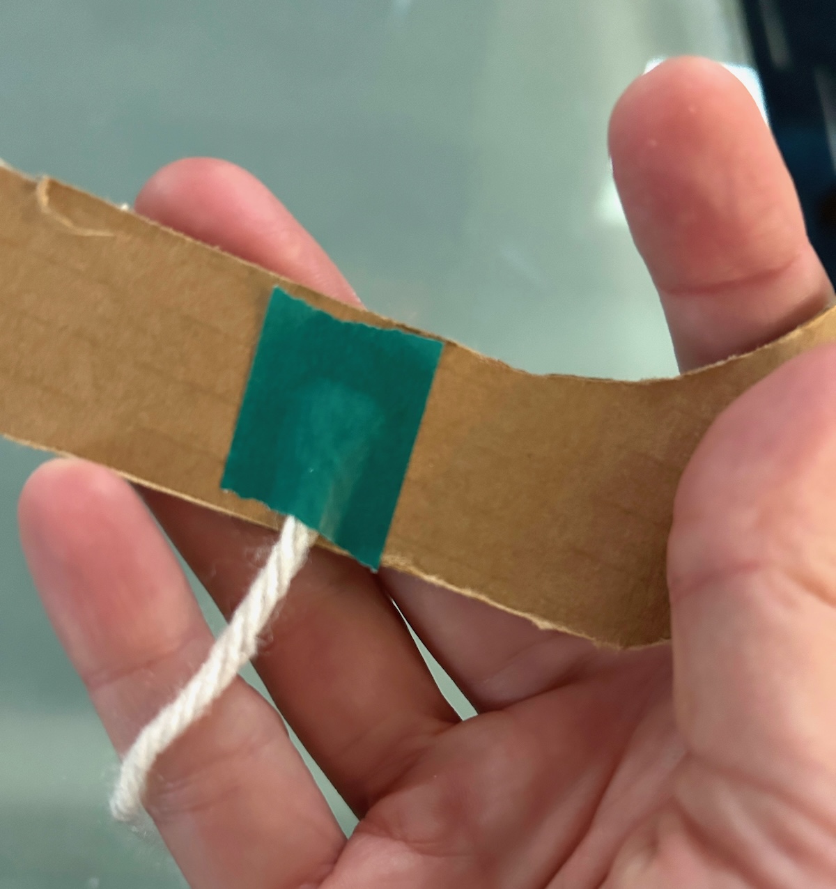 yarn taped to the back of the cardboard