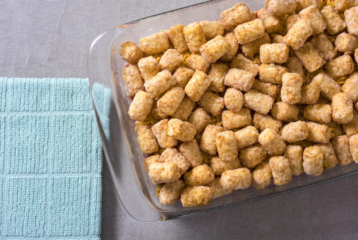 Frozen tater tots spread on top of the casserole