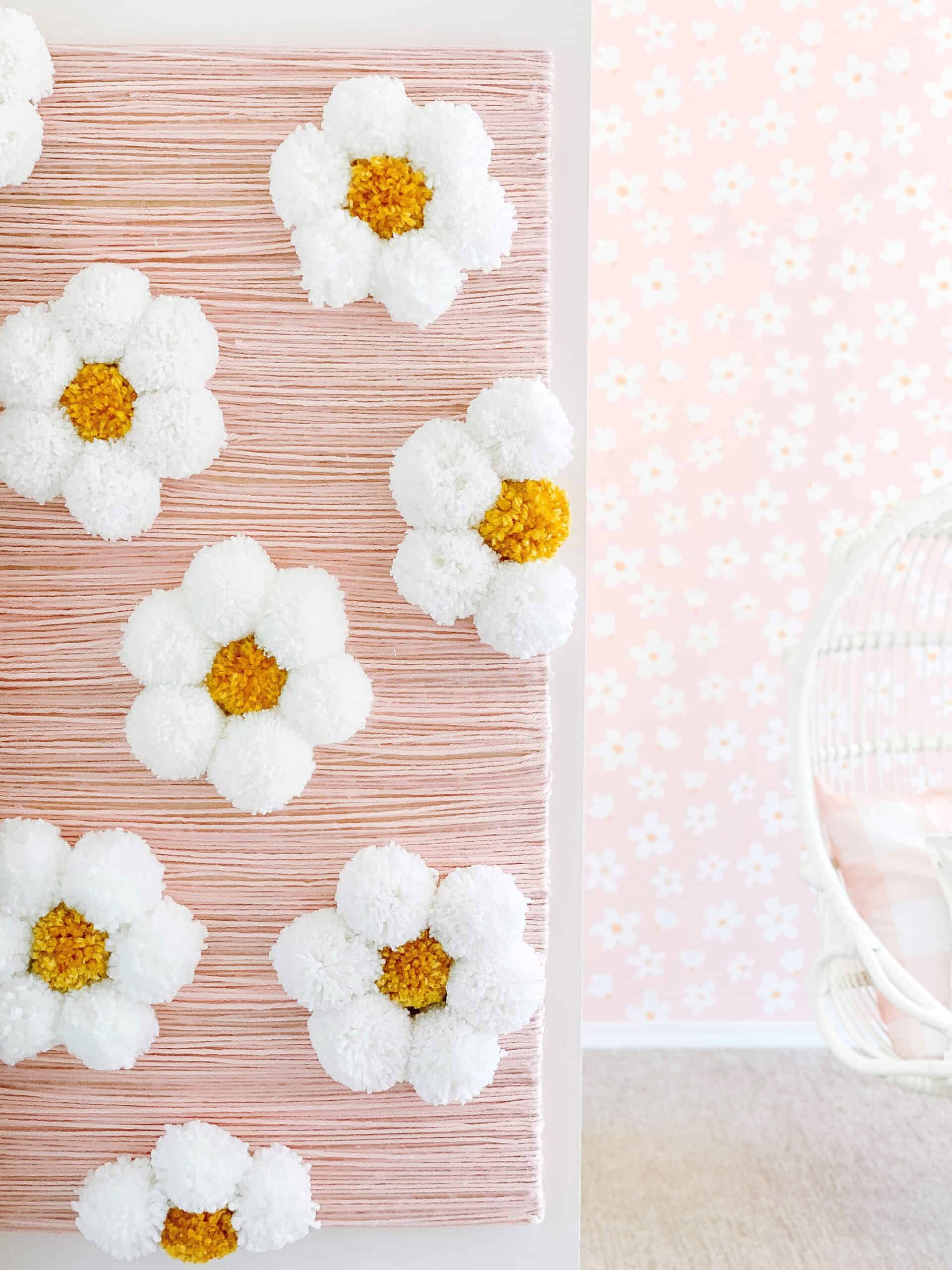 Easy yarn wall art with pom pom flowers