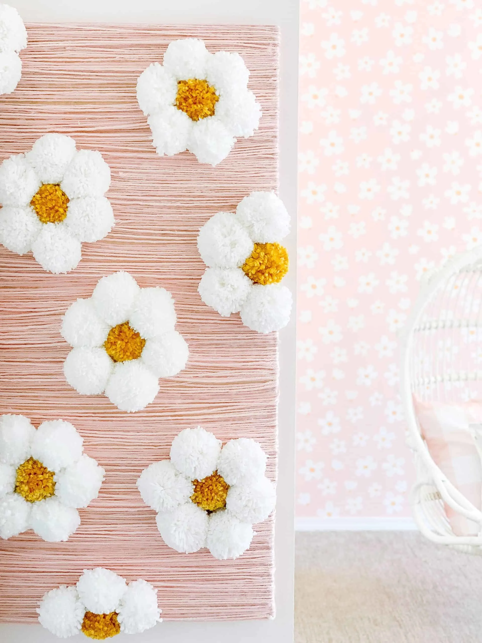 Easy yarn wall art with pom pom flowers