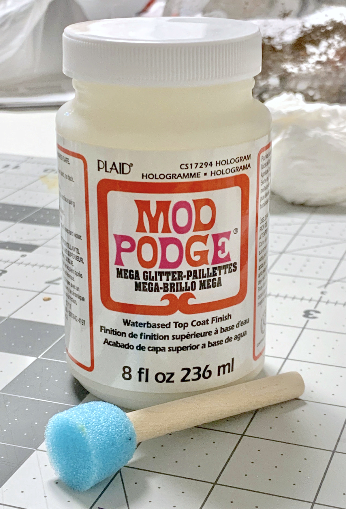 A bottle of Mega Glitter Mod Podge with a spouncer