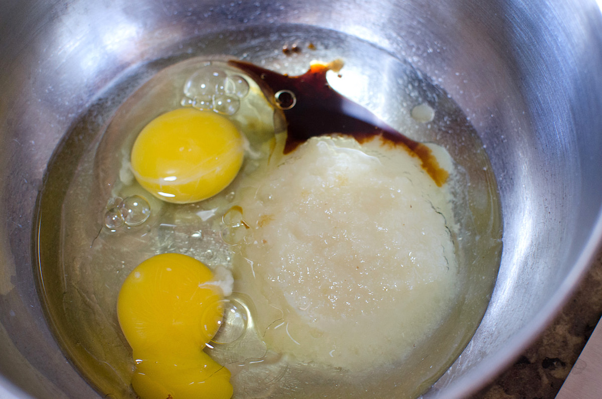Bowl with eggs oil applesauce and vanilla