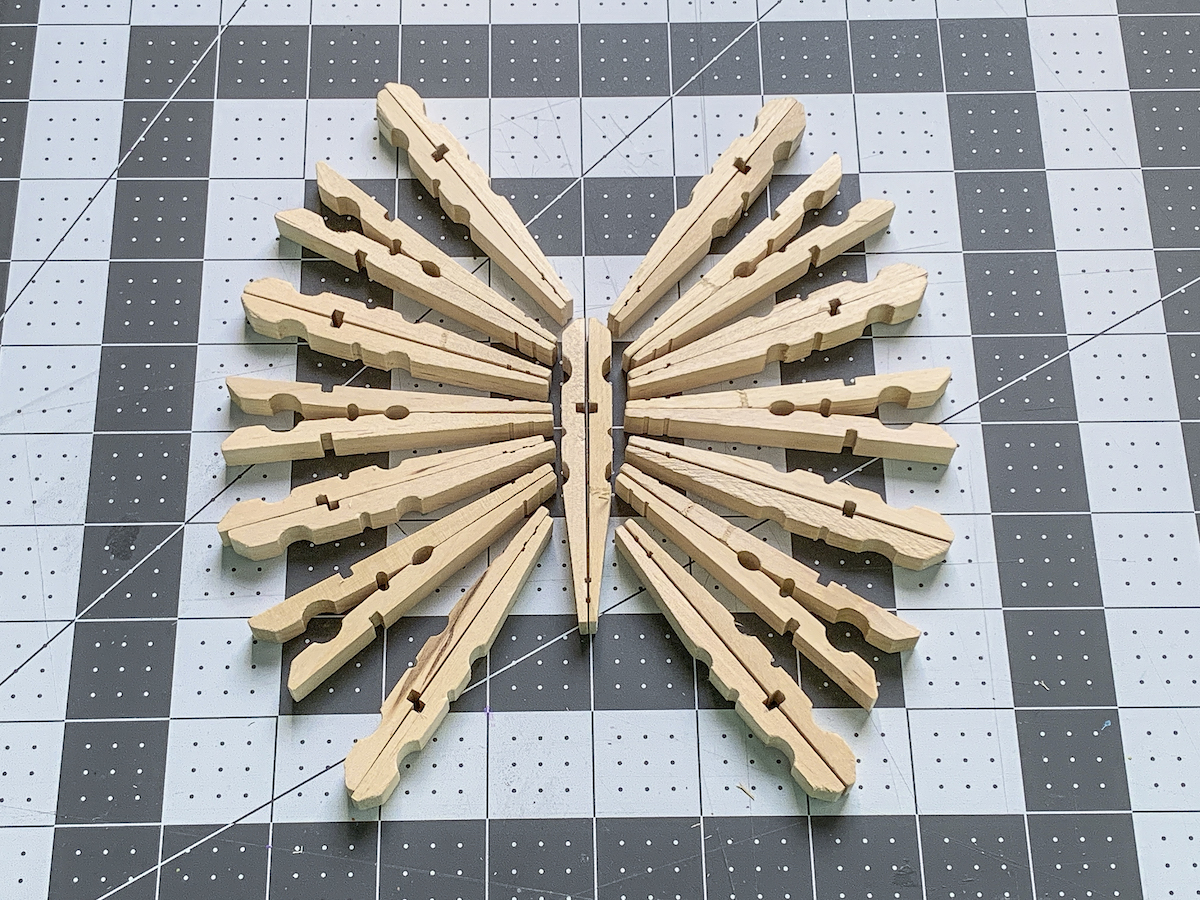 Clothespins laid out in a butterfly shape