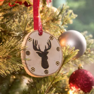 Deer head wood slice ornament on a Christmas tree